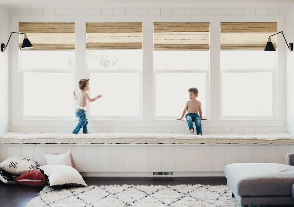 kids playing on a long window seat wool cushion