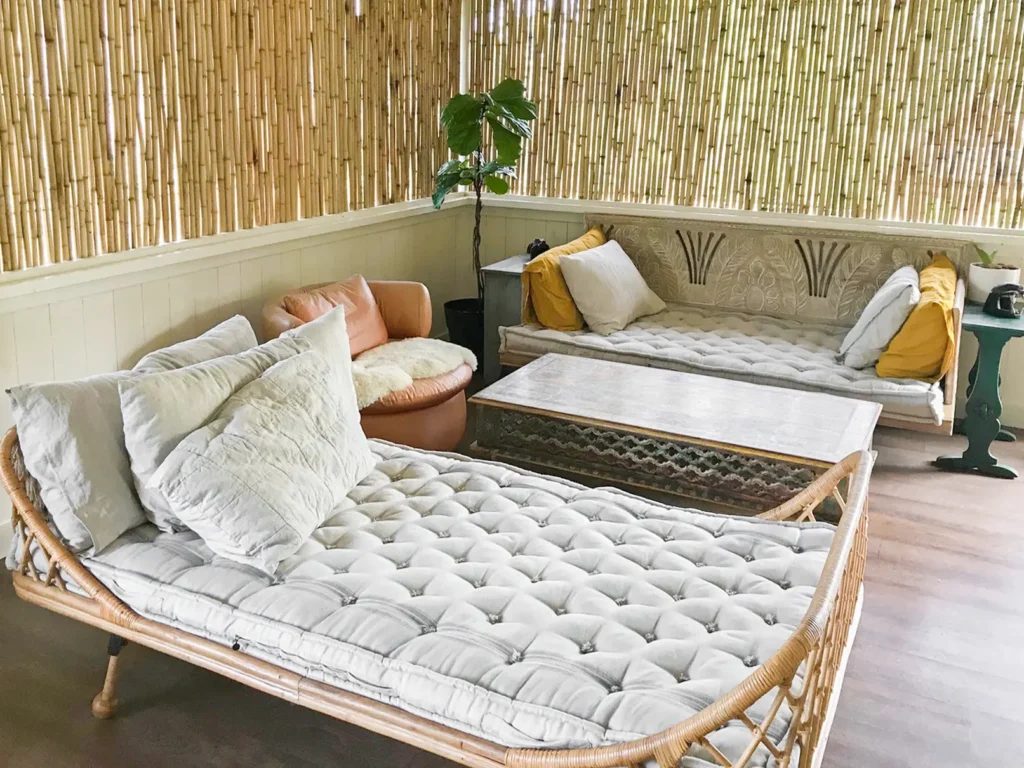 boho lounge area with rattan furniture wool mattresses and bamboo walls