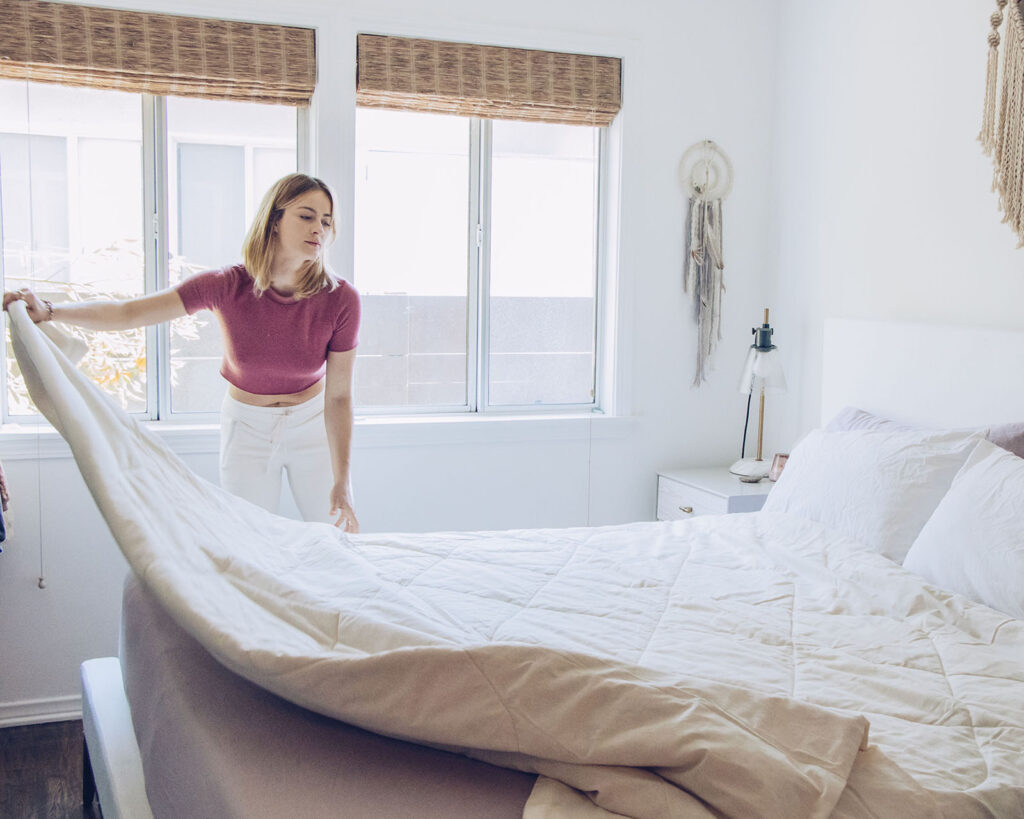 woman fixing a bed