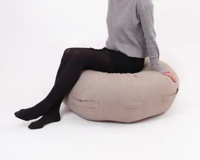 Home of Wool round ottoman cushion with model