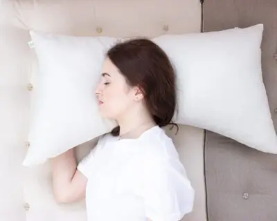 model sleeping on a curved side sleeper pillow - from the top