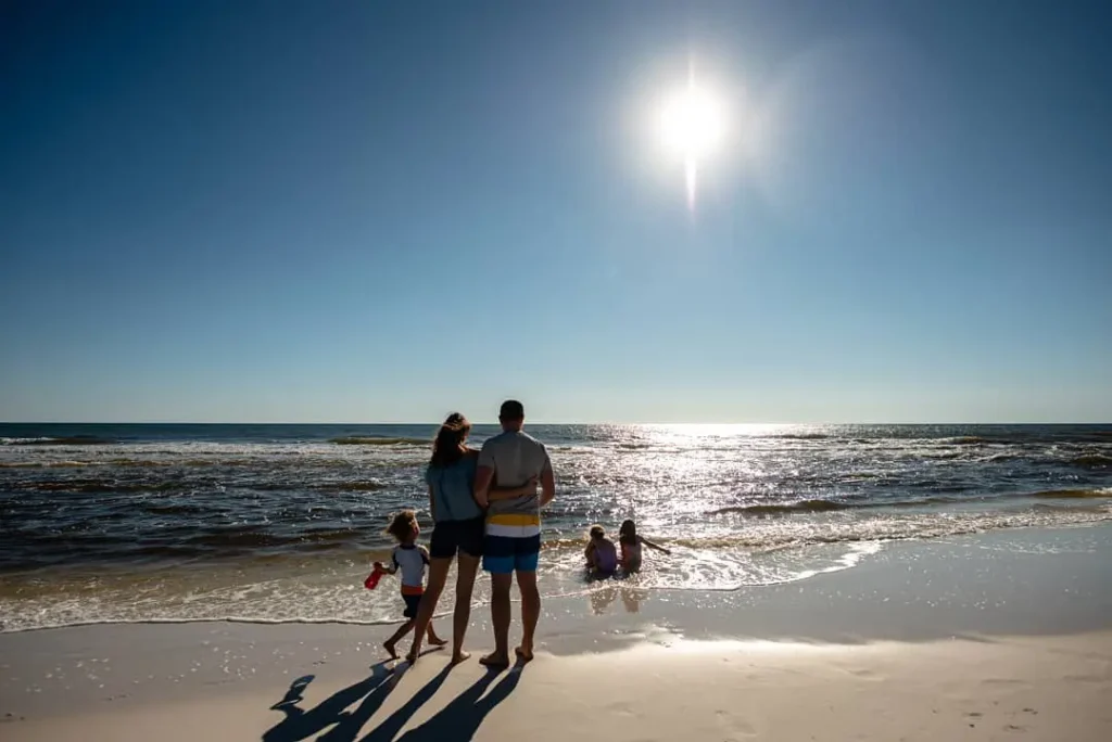 man woman and children by the sea