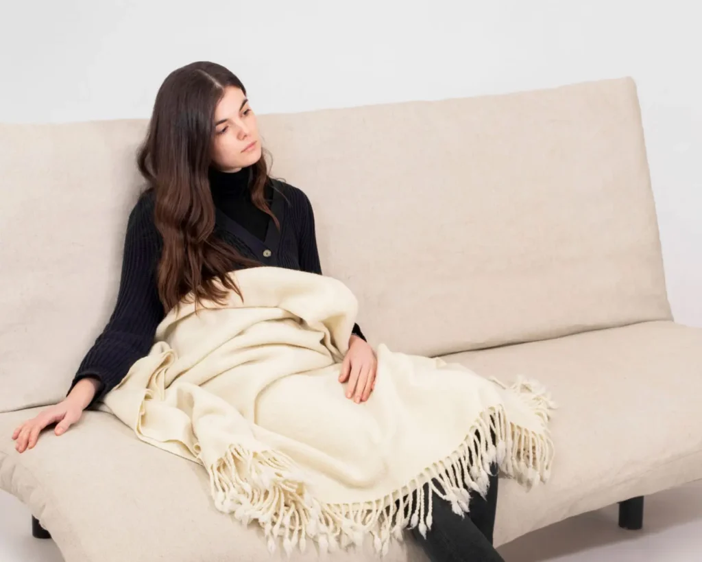 woman sitting on futon mattress with natural willing
