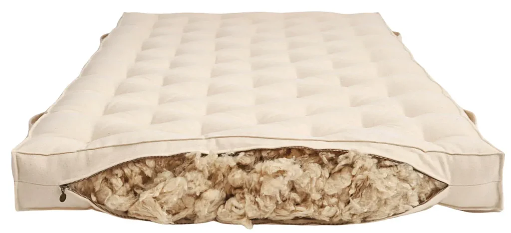 unzipped wool mattress revealing wool inside