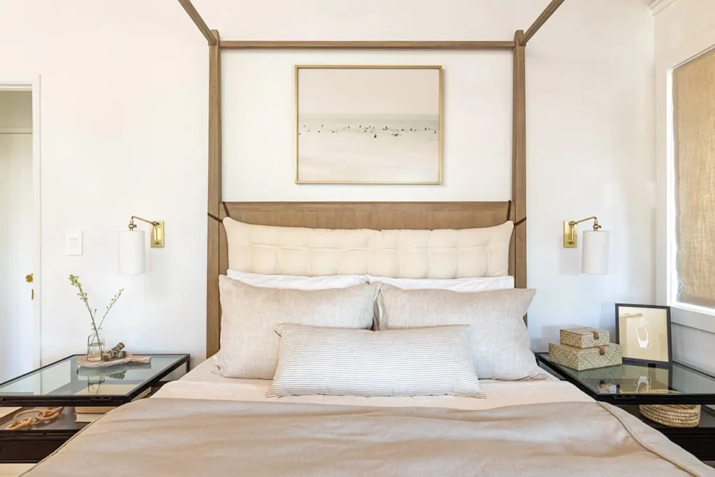 cozy room with a large bed frame with a wool bed, a duvet and many pillows