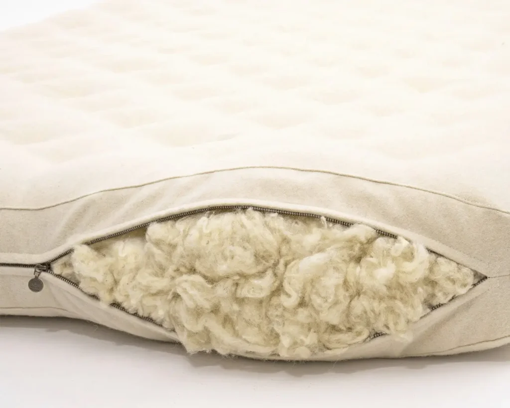unzipped home of wool mattress revealing filling