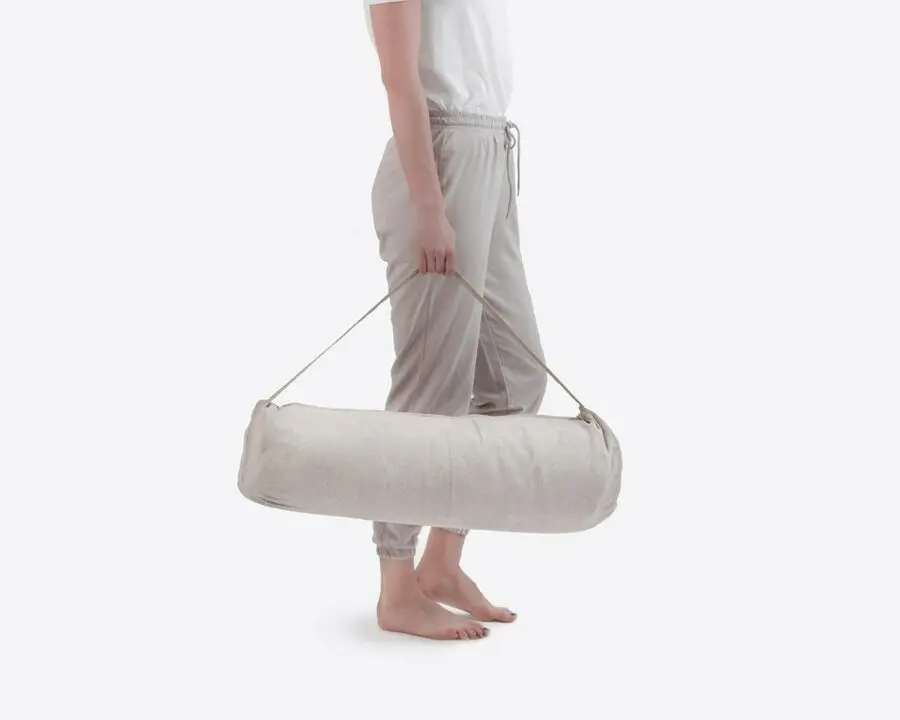 Home of Wool custom floor sleeping mat in carry bag with model