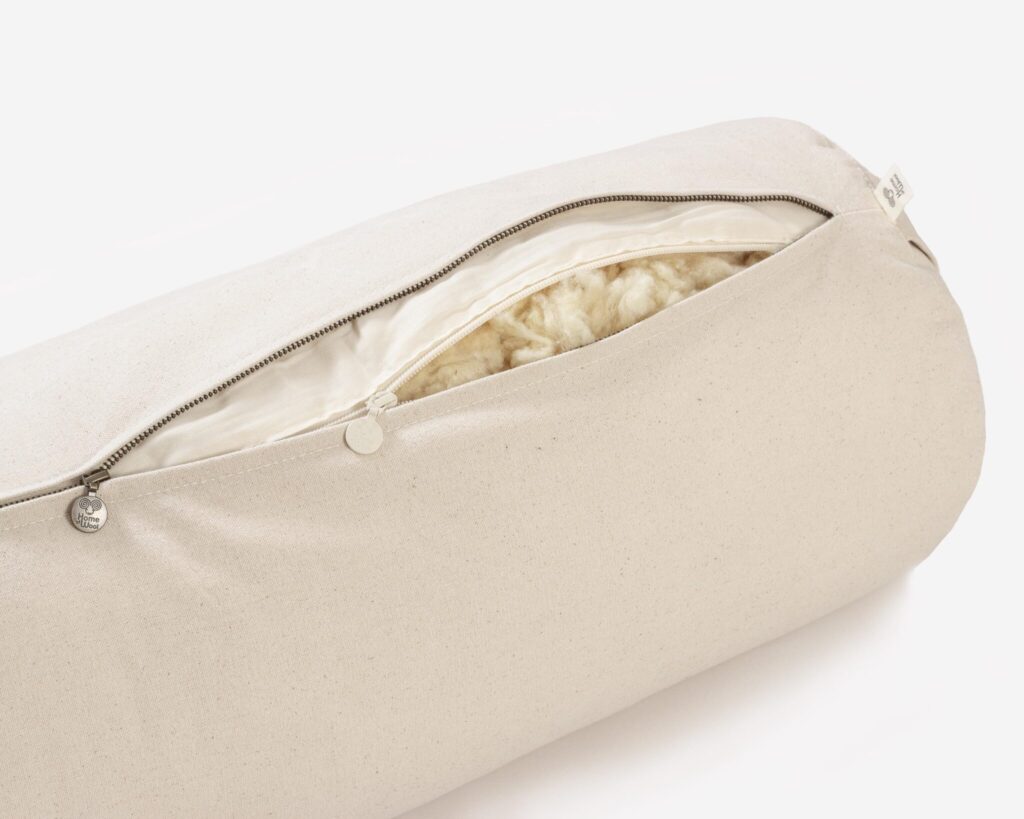 unzipped wool yoga bolster revealing wool inside