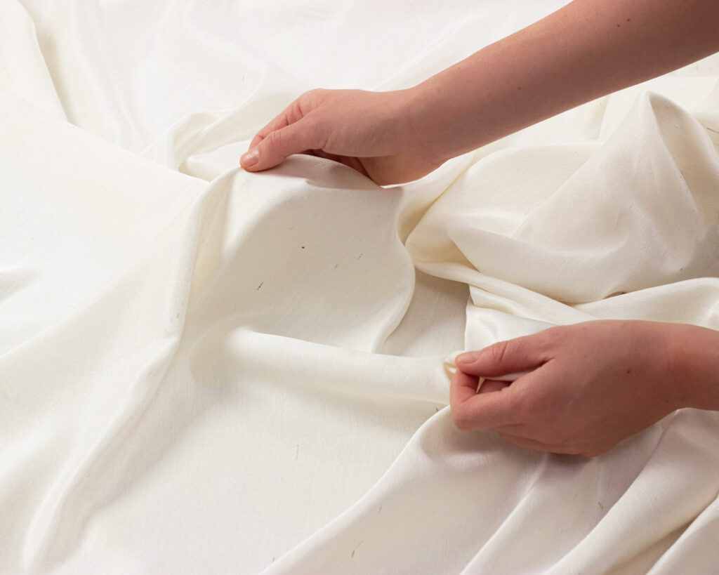 manos sosteniendo tela de seda