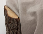 linen fabric folded over a piece of wood