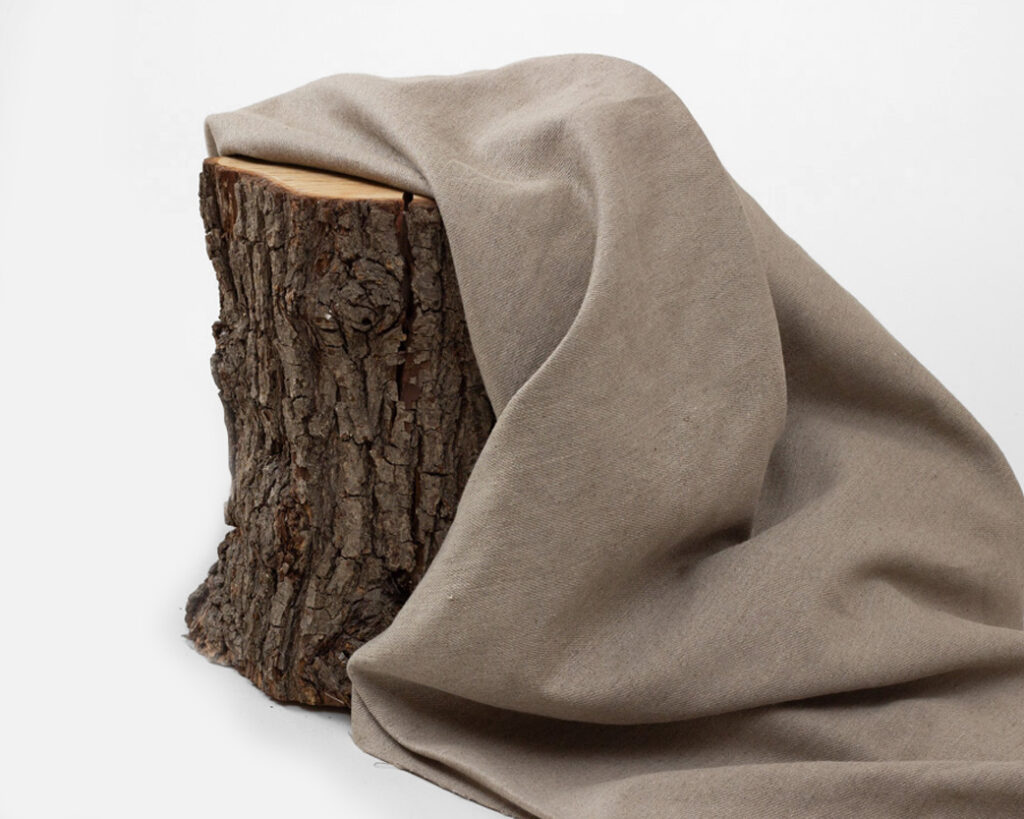linen fabric folded over a piece of wood