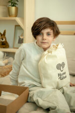 gelukkige jongen met zelfgemaakte knuffeldieren van wol