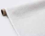 linen fabric with thin grey stripes rolled out flat