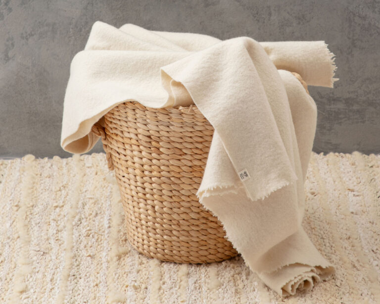 pure virgin wool blanket in a basket on a zero waste rug