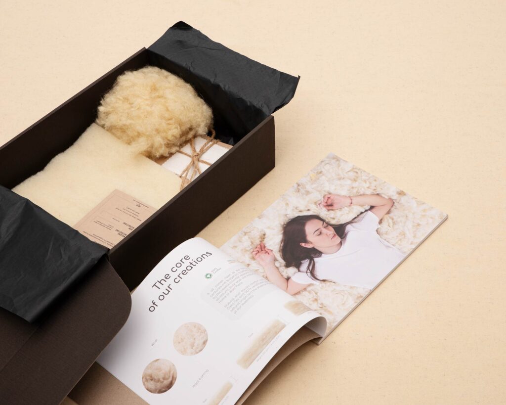 open home of wool product catalogue with wool and fabric samples inside the box