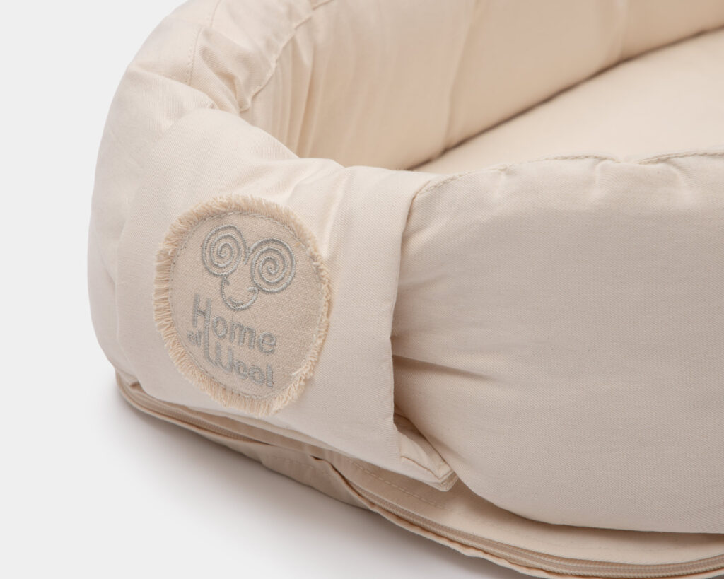 wool baby nest from 100% organic cotton embroidery home of wool logo
