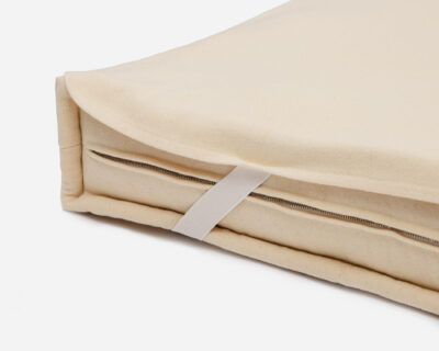 wool mattress protector showing how it attaches to the wool mattress