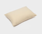 wool pillow protector on a pillow on a white background
