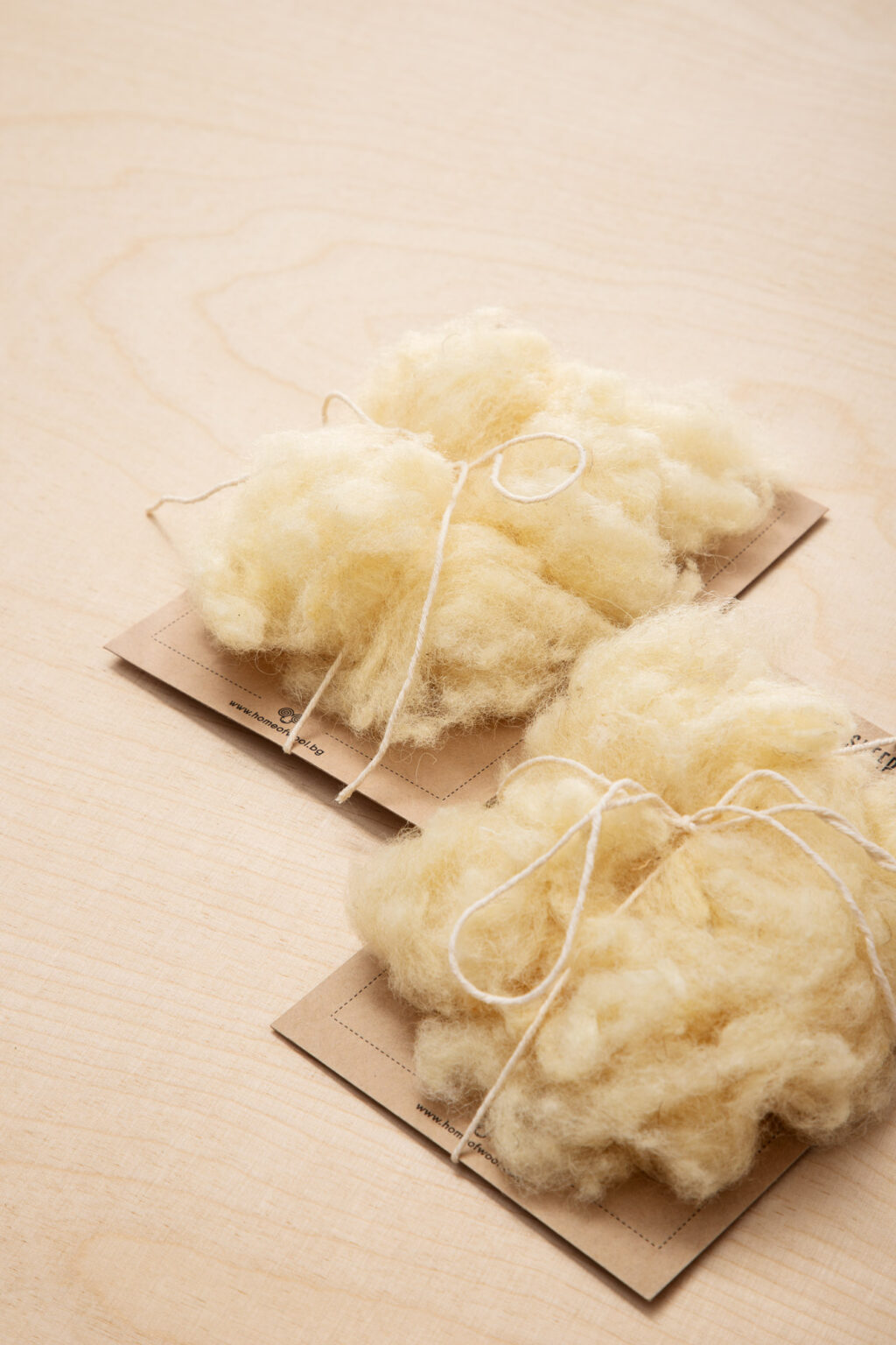 two pieces of wool on cardboard tied with jude twine