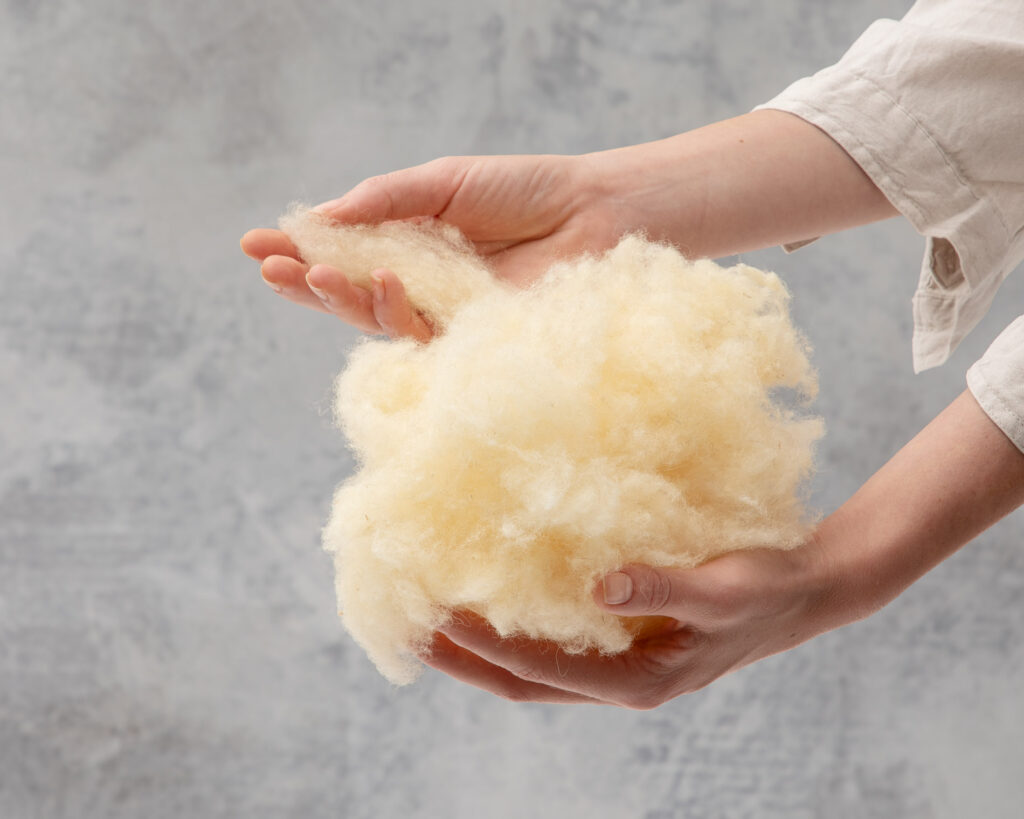 a handful of wool being held by a hand