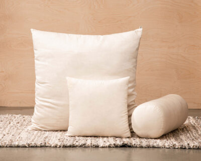 different shapes of wool pillows with wool filling on a zero waste rug