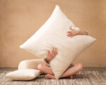 big pillow with wool filling being held by a person